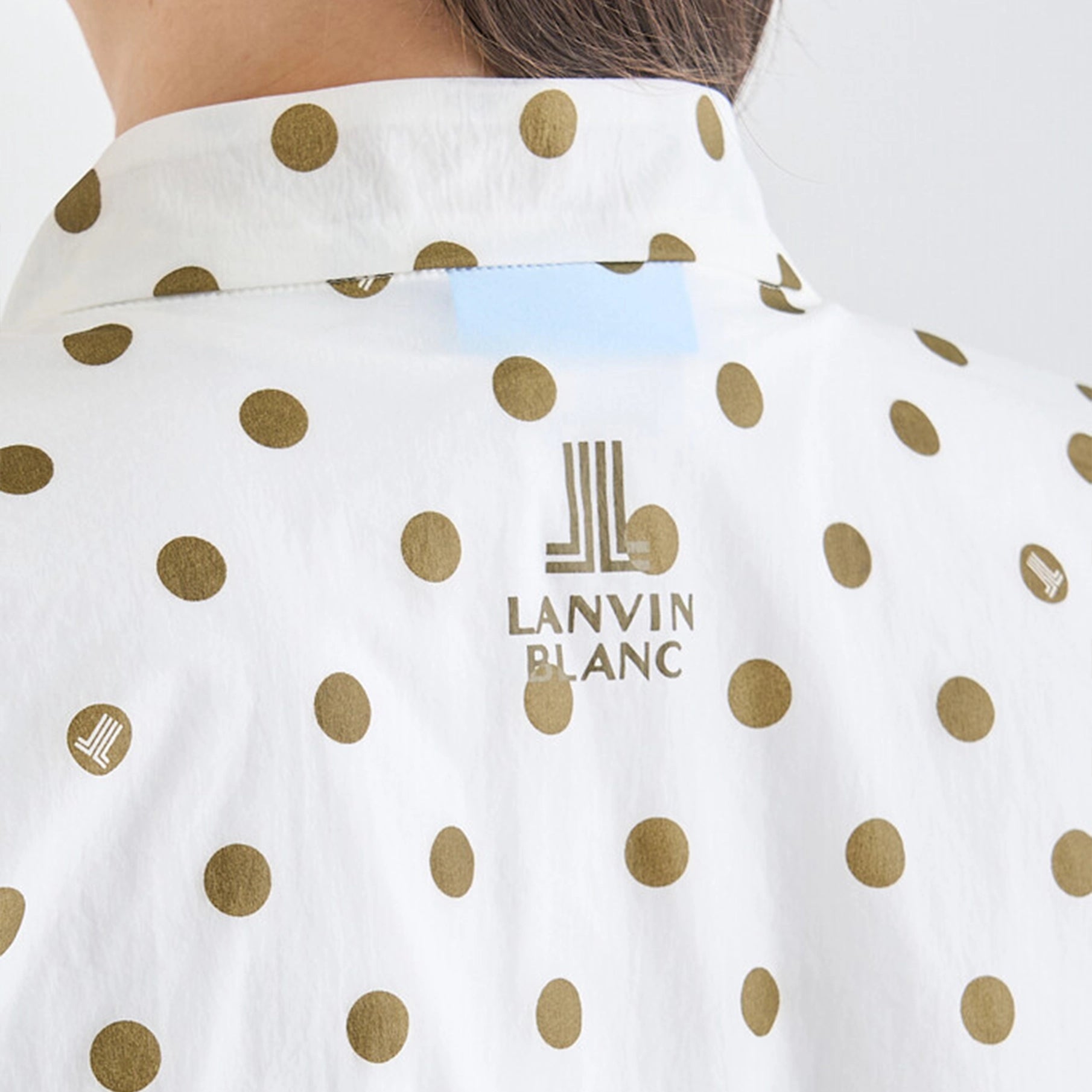 White garment with gold polka dots and 'Lanvin Blanc' logo