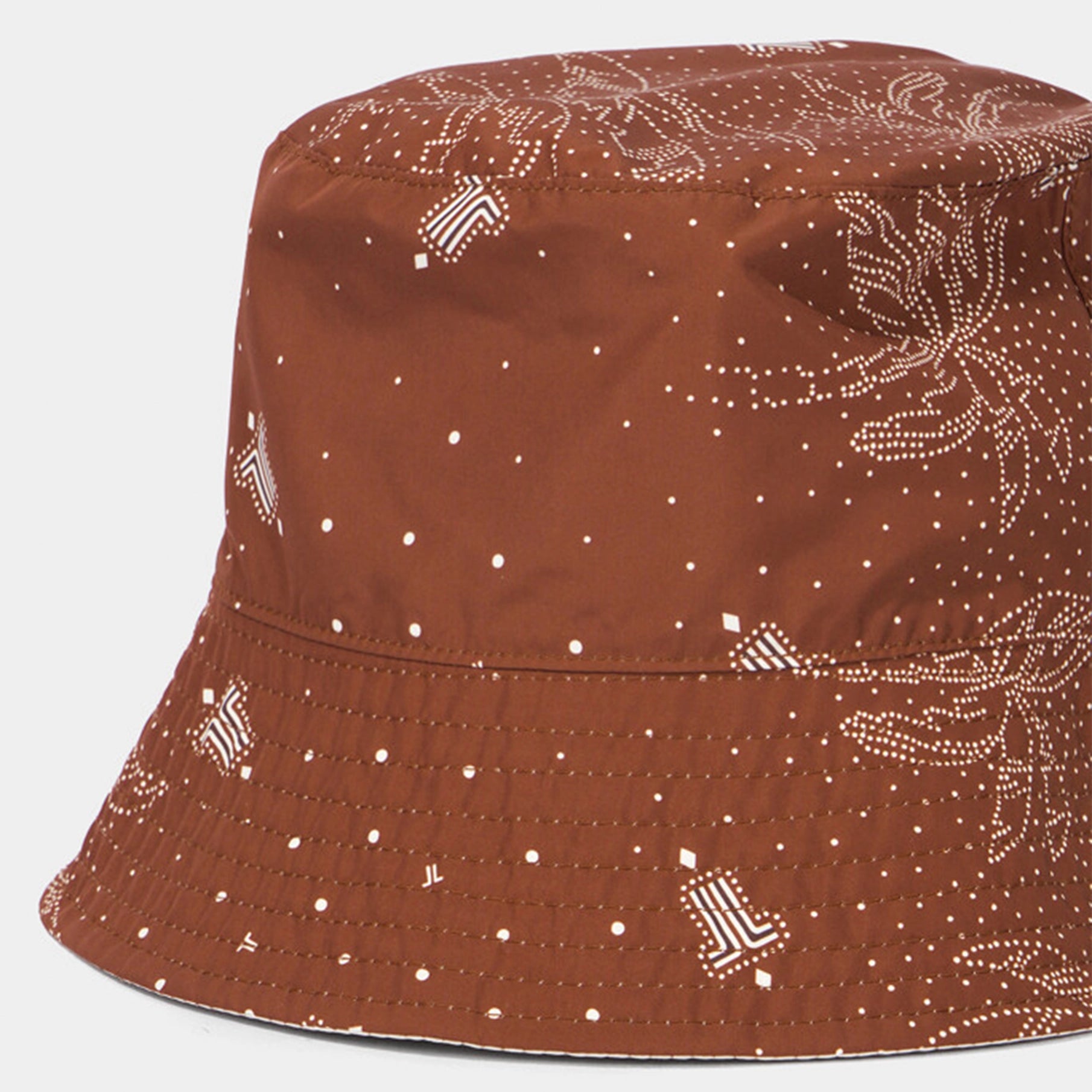 Brown bucket hat with white pattern on a white background