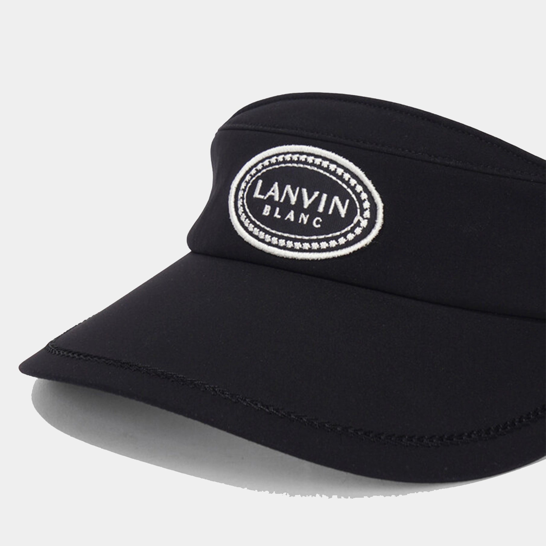 Black visor with 'Lanvin Blanc' logo on a light gray background