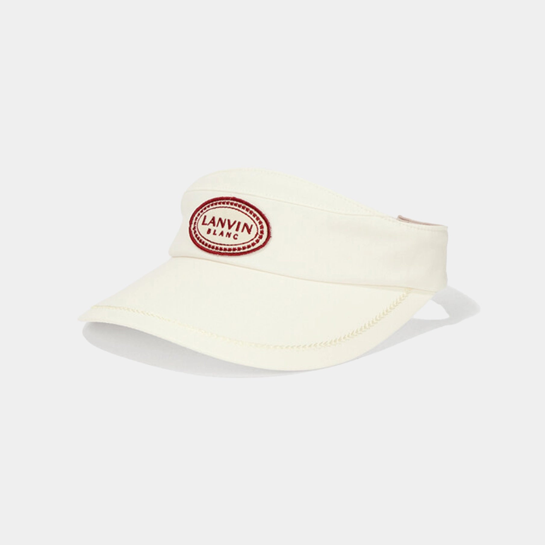 Cream-colored visor with red logo on a white background