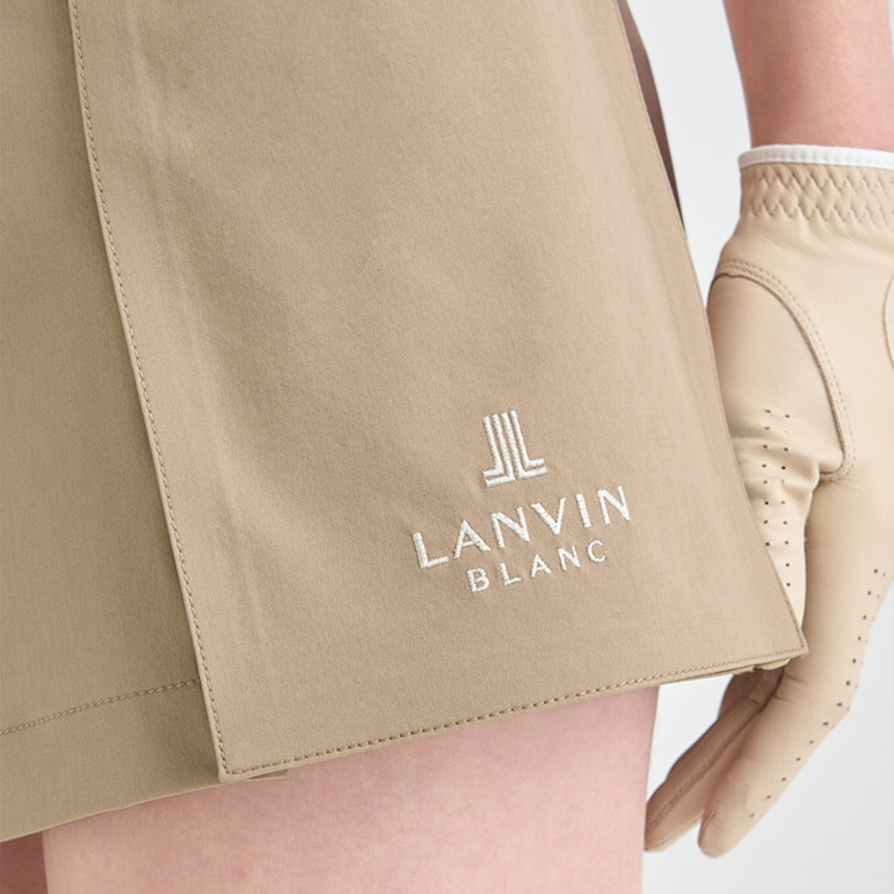 Beige shorts with 'Lanvin Blanc' logo on a white background