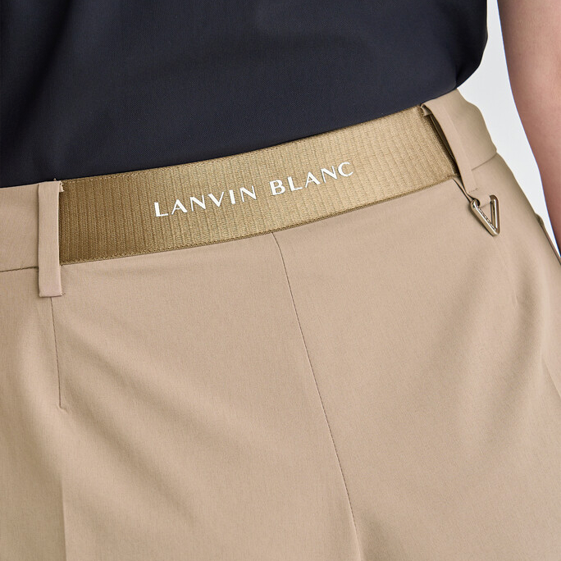 Beige pants with a brown belt featuring 'LANVIN BLANC' branding.