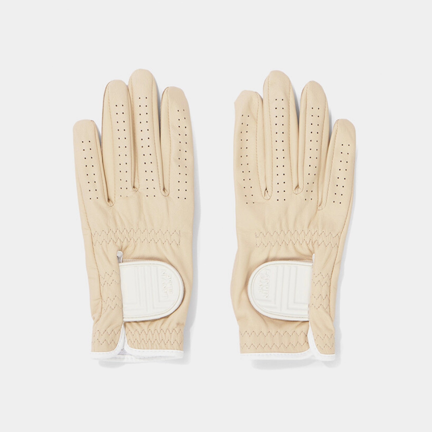 Pair of beige gloves with white accents on a light gray background