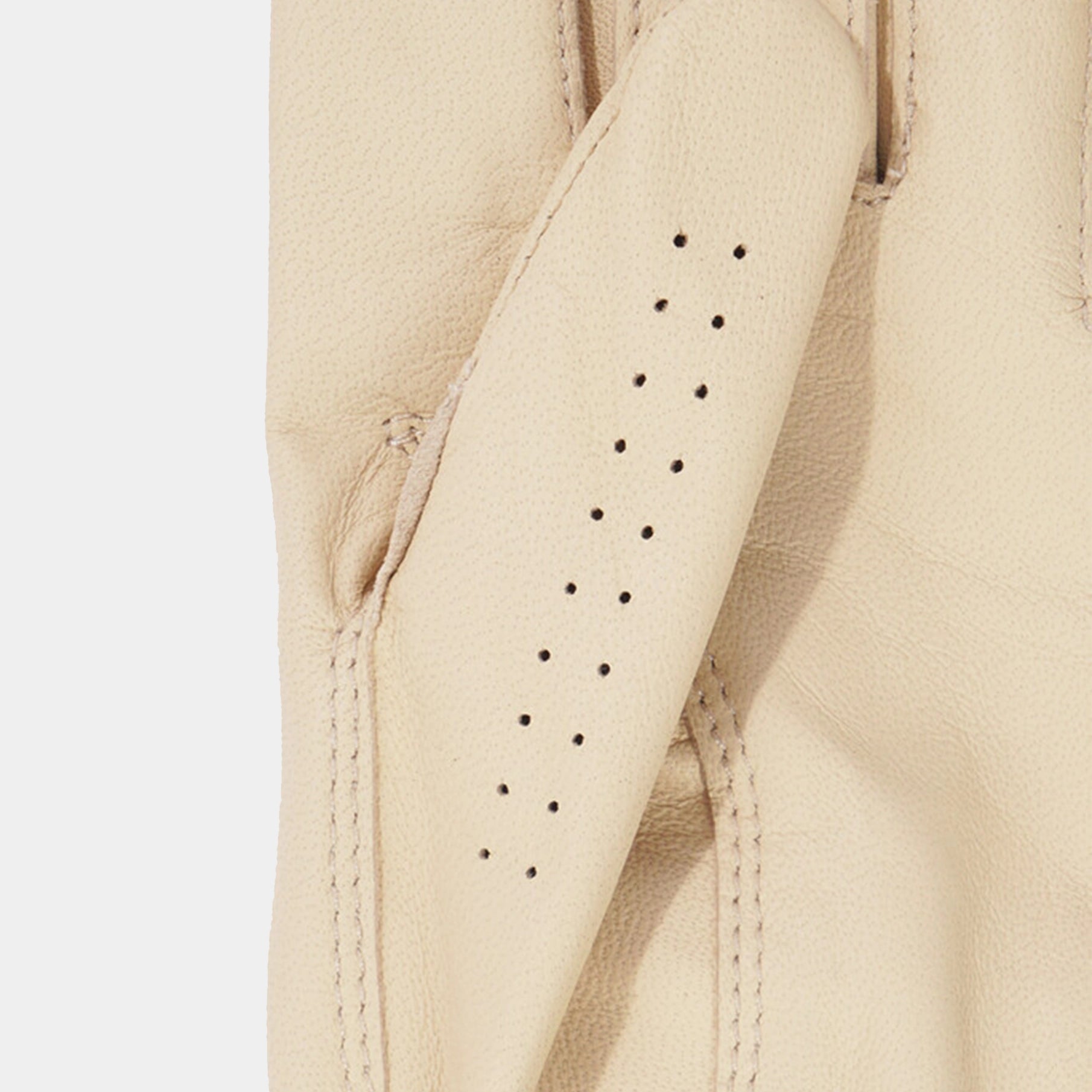Close-up of beige leather glove with black stitching on a light gray background