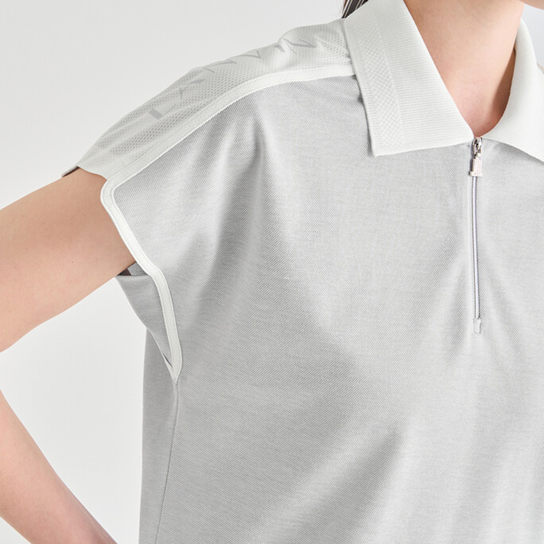 Gray polo shirt with white accents on a plain background
