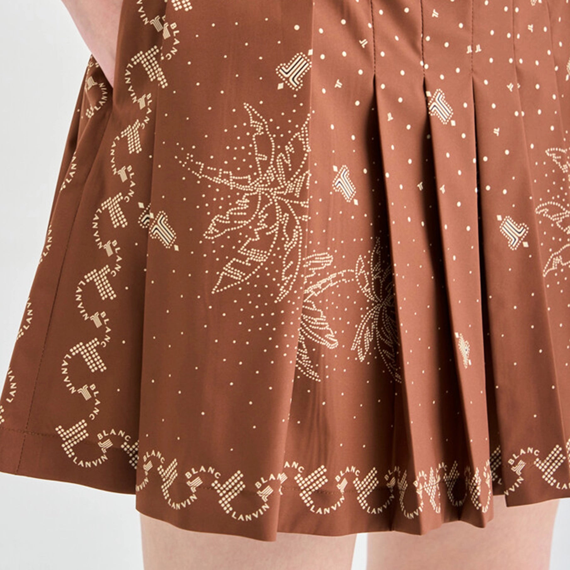Brown skirt with intricate white patterns on a plain background
