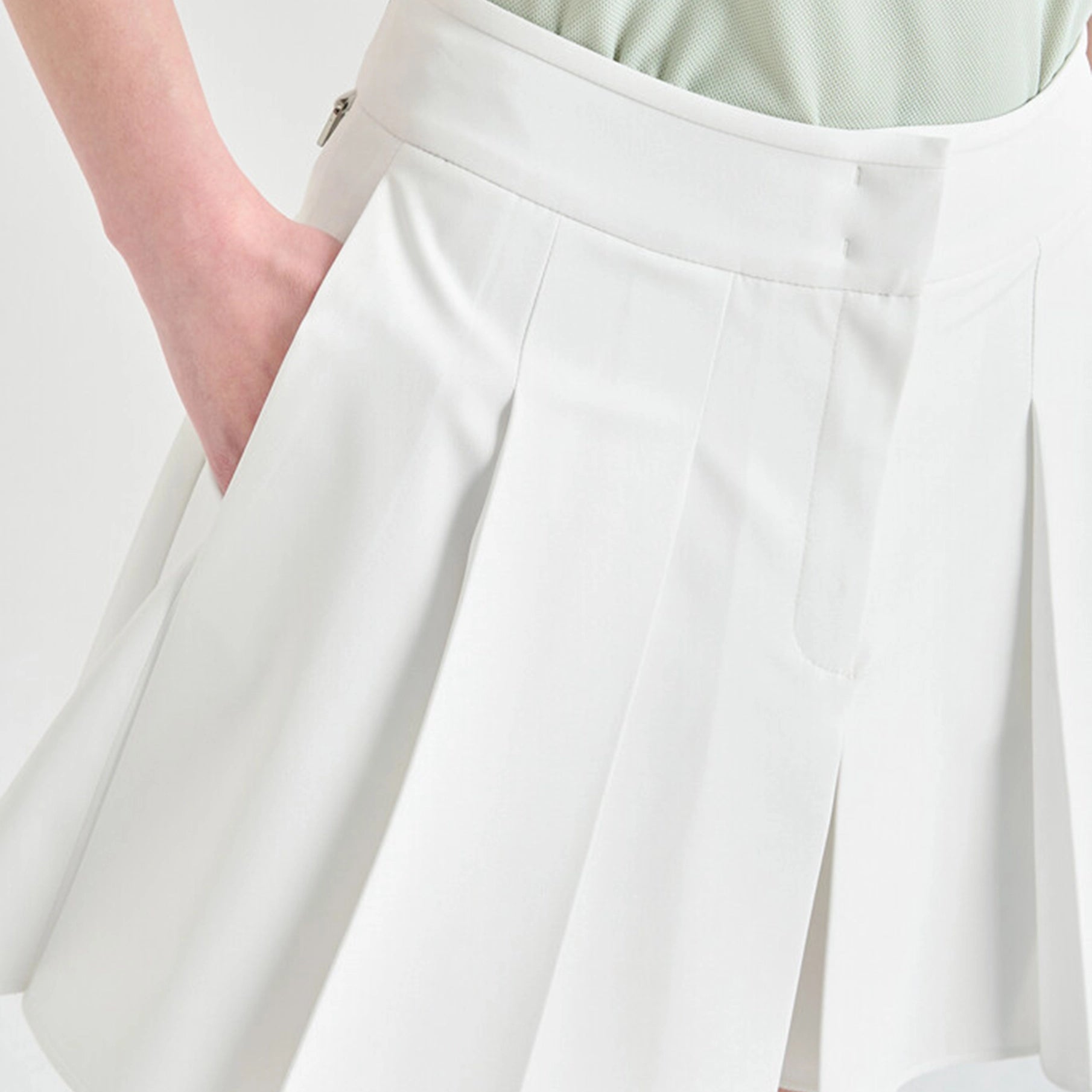 White skirt with a person wearing it on a light background