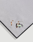 Close-up of gray magnetic golf towel showing textured fabric with embroidered golfer and golf cart detail - Laclavi Golf