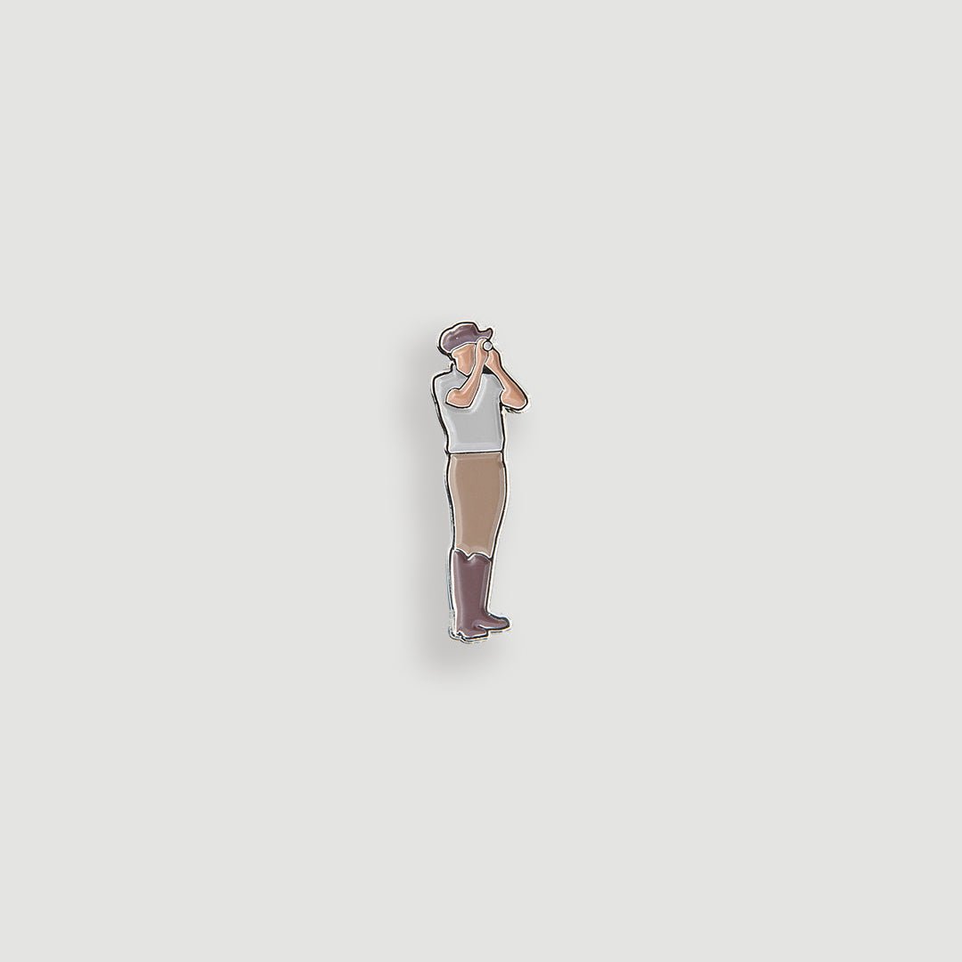 Gray enamel figural golfer ball marker pin showing golfer looking through binoculars on fairway - Laclavi Golf
