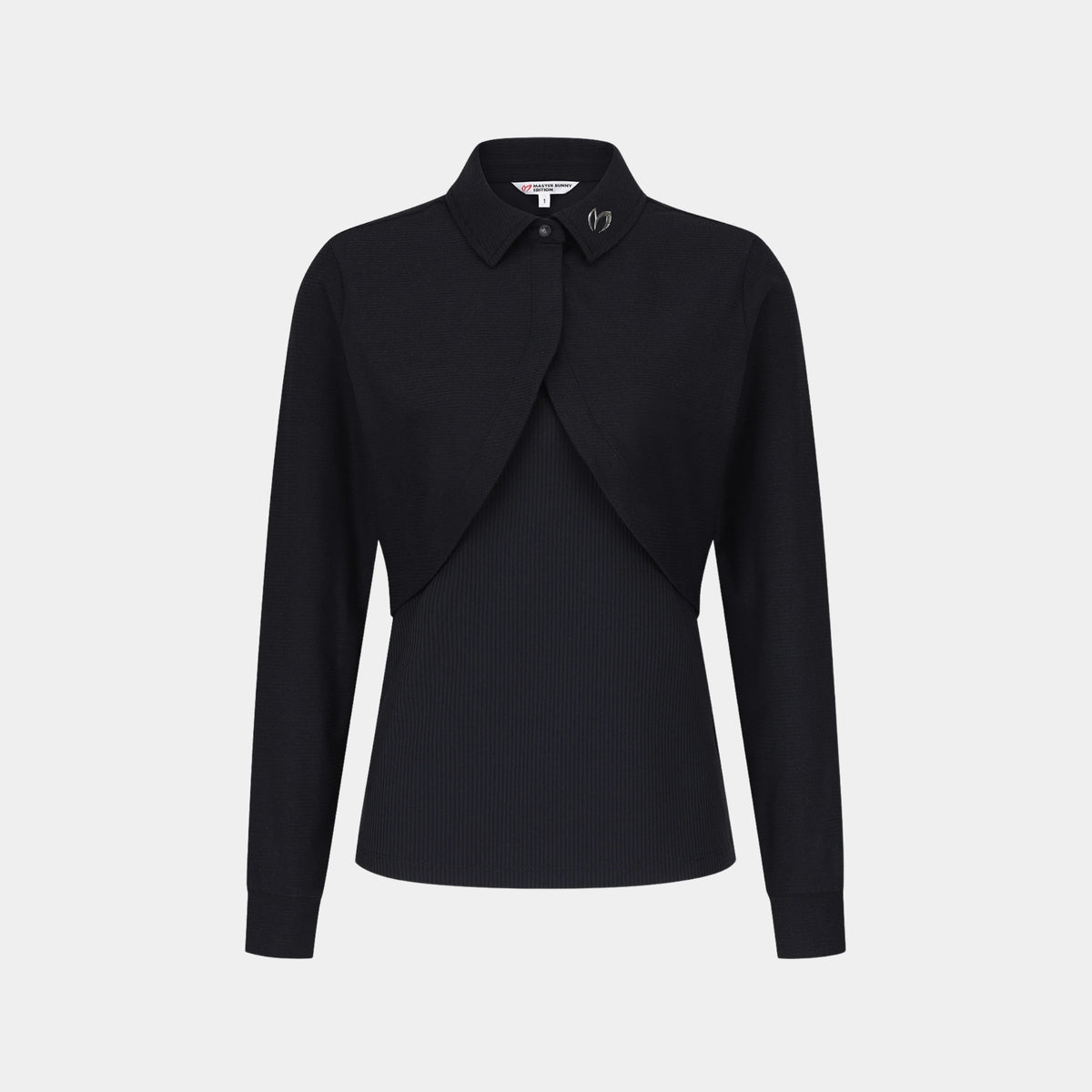 A black long-sleeve collared blouse with a draped, asymmetrical front overlay and subtle vertical ribbing, shown on a light gray background.