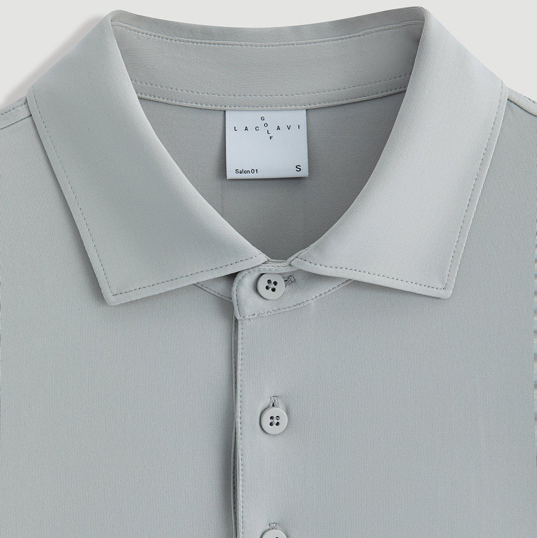 Gray men's cowboy performance polo collar detail with Laclavi Golf woven label and button placket close-up - Laclavi Golf