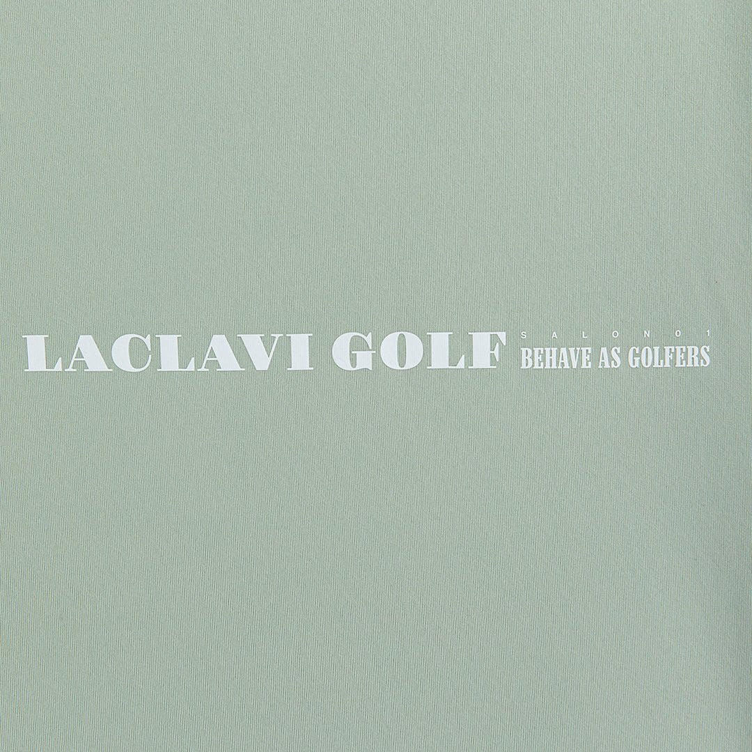 Green polo fabric brand graphic with Laclavi Golf Salon 01 Behave As Golfers slogan text - Laclavi Golf