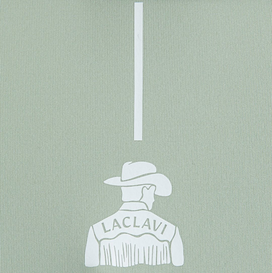 Green polo fabric close-up showing white cowboy golfer illustration with Laclavi Golf branding at flagstick - Laclavi Golf