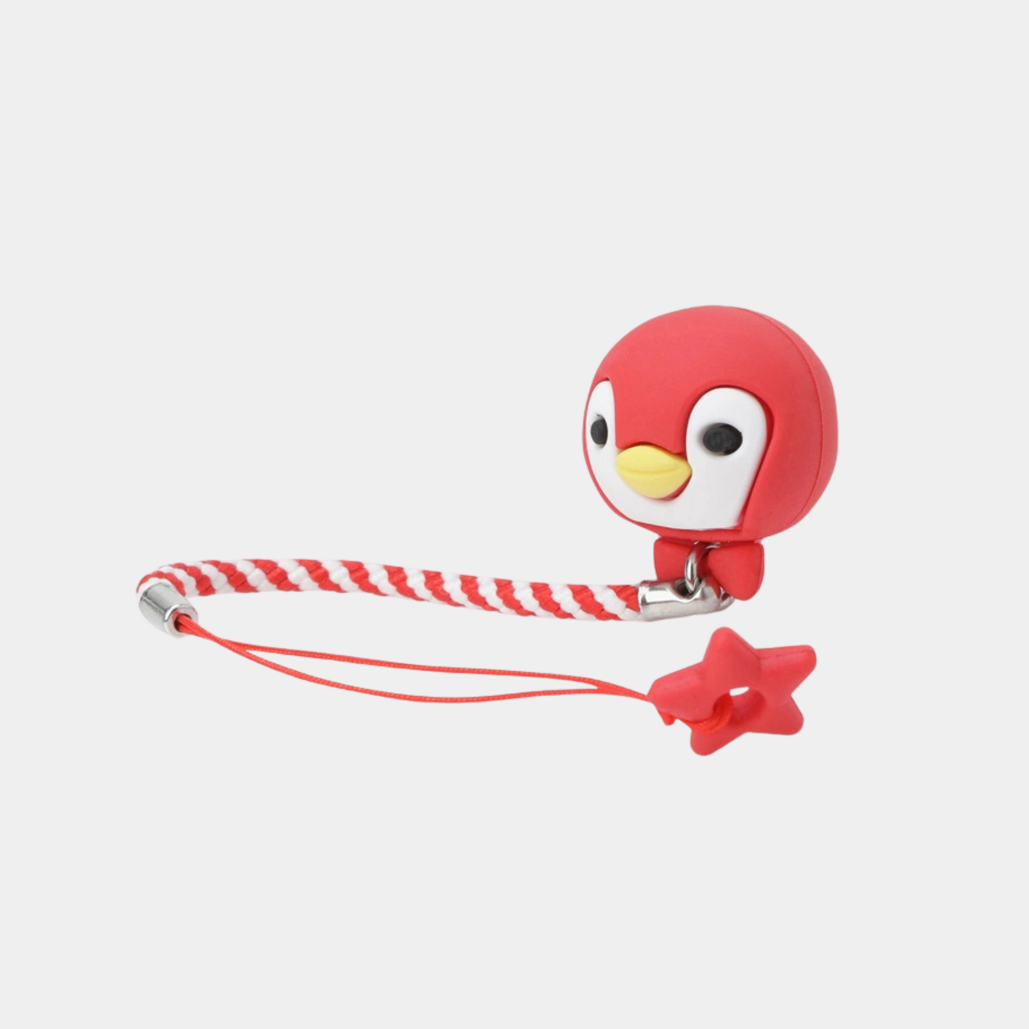 A red penguin-shaped tee holder with a red-and-white braided cord, silver metal hardware, and a small red star charm, shown on a light gray background.