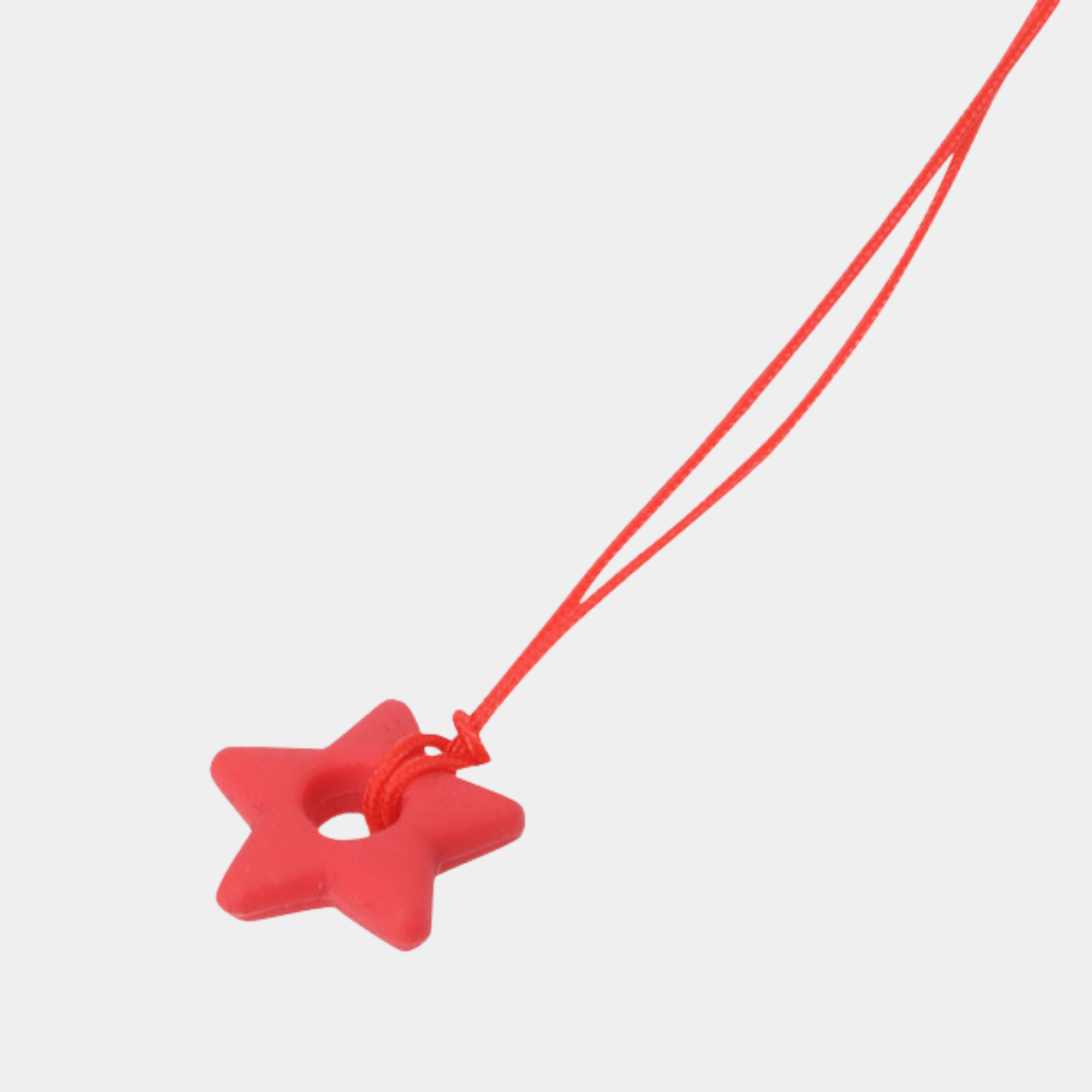 A red silicone star-shaped ring with a matching red cord, shown against a plain light gray background.