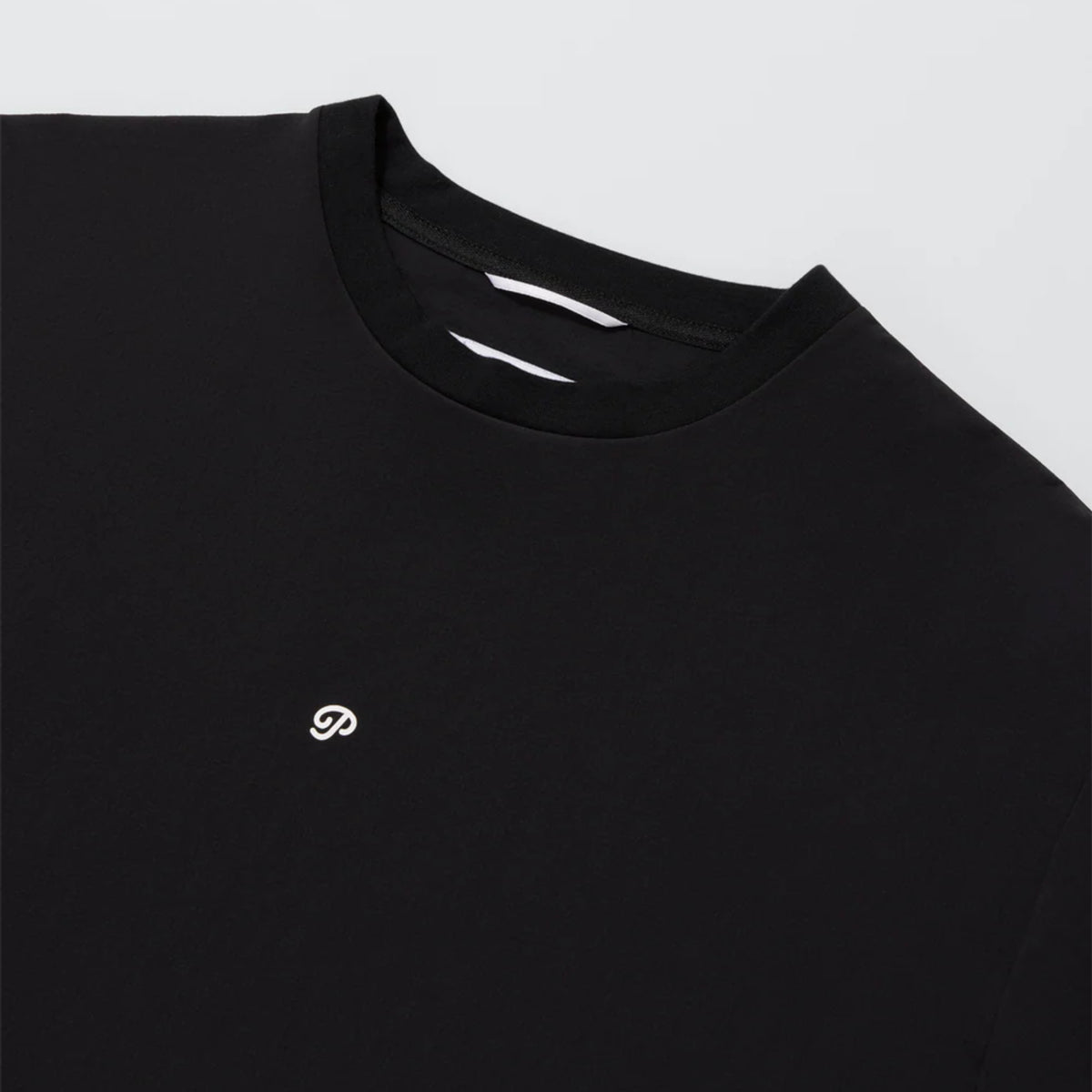 Close-up of the black golf shirt.