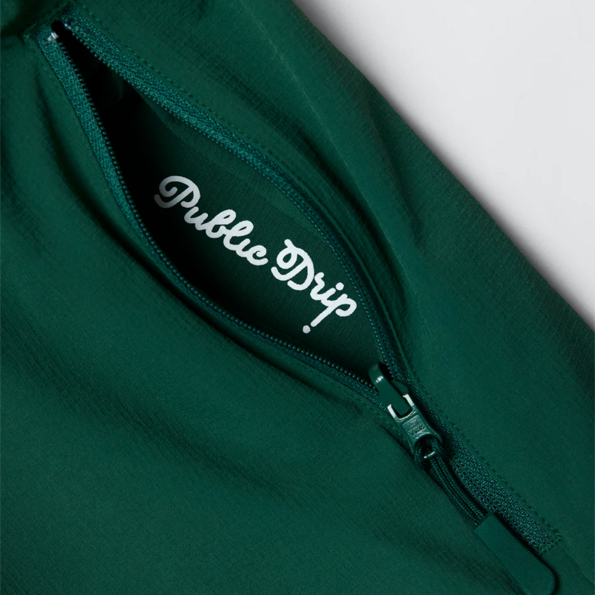 Close-up of the green shirt’s side zip pocket.