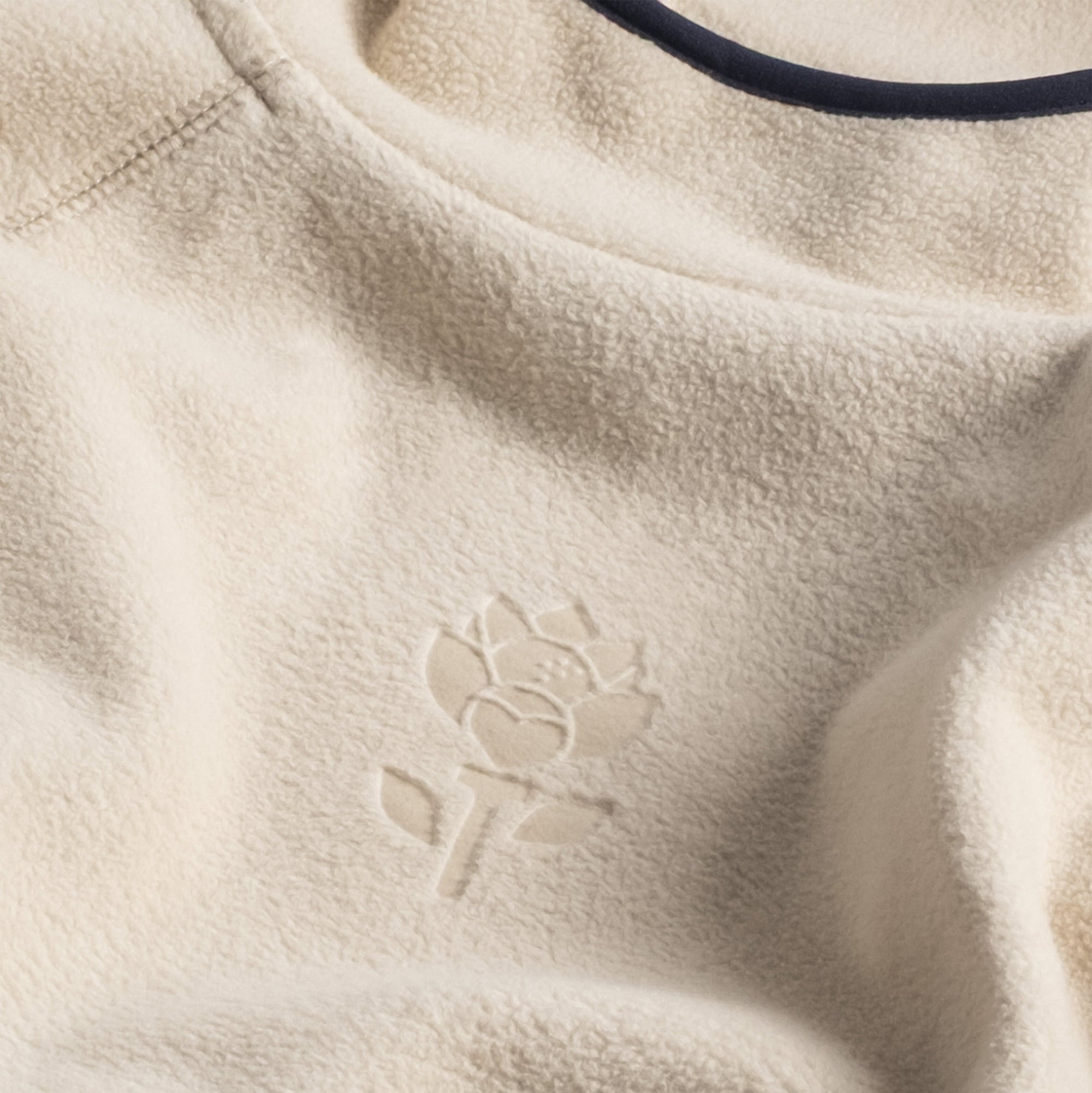 Detailed view of the fabric and the embossed flower in Men's Hoodie - Beige - Erthe Golf