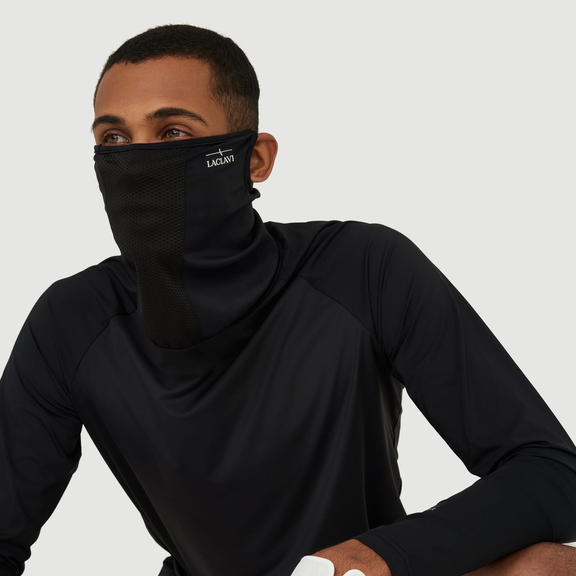 Male golfer wearing black UV shield neck gaiter with long-sleeve athletic shirt for sun protection - Laclavi Golf