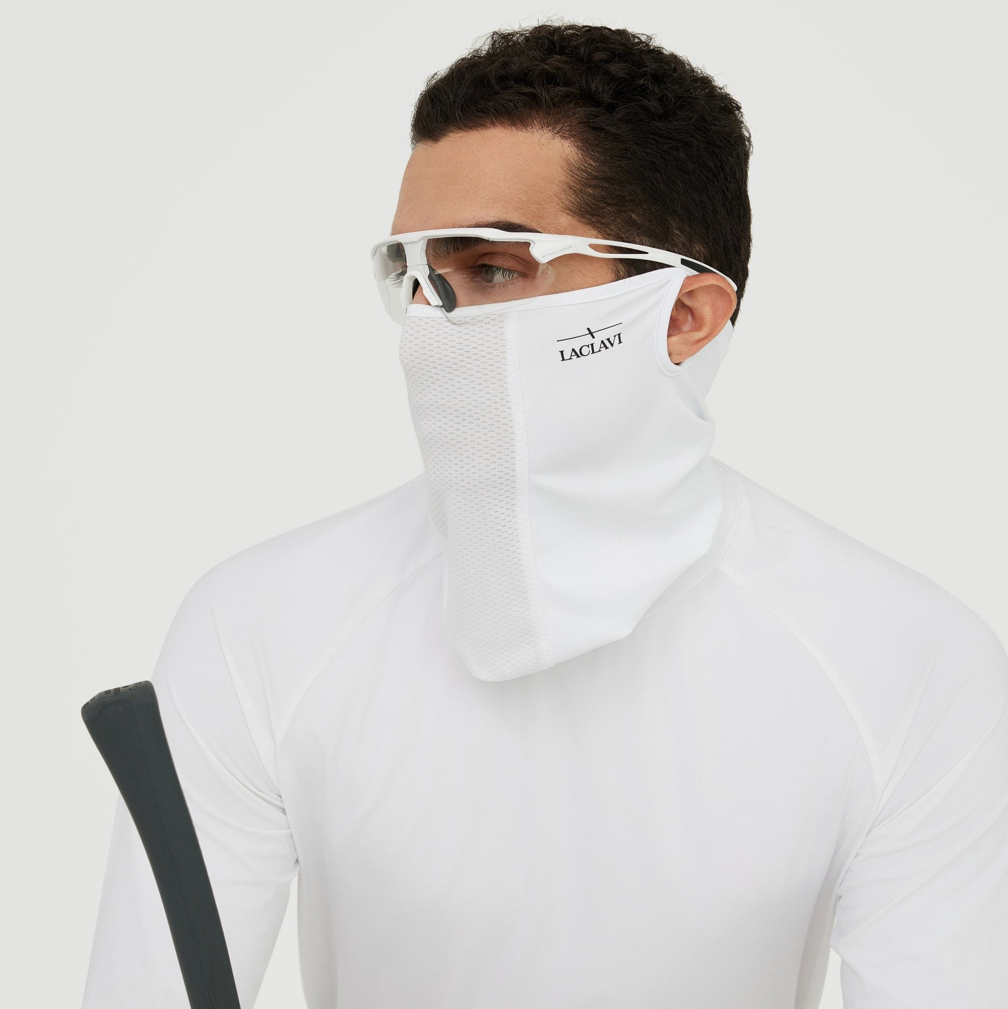 Male golfer wearing white UV shield neck gaiter with sport sunglasses and long-sleeve shirt on course - Laclavi Golf