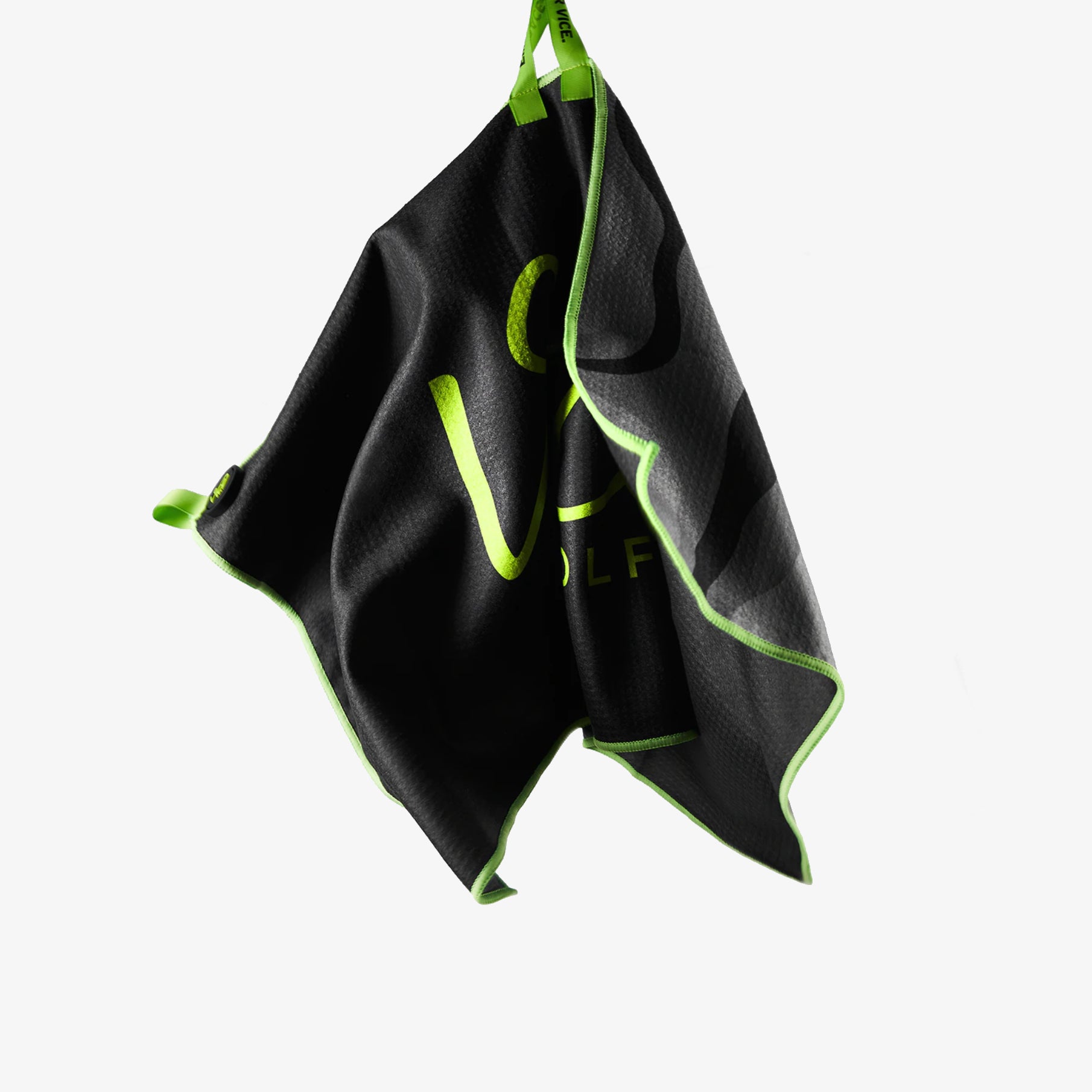 Black towel with green trim hanging on a white background